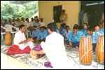 Social Fitment: Mridangam Teacher explains to the trainees how to play the instrument., click here to see large picture.