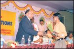 Distinguished guest Chief Justice Sri Devinder Gupta, felicitates Sri J. M. Arun Kumar of LEKHADEEP on his getting AP State Award 2001-02 as Best MR Employee, click here to see large picture.