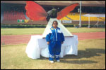 Ms M. SRAVANTHI with the Logo of Special Olympics National Games 2002 at New Delhi, click here to see large picture.